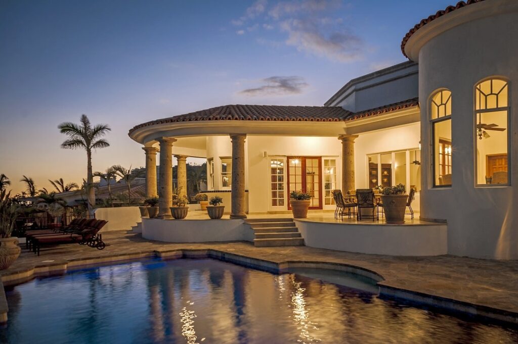 Villa Paraiso illuminated infinity pool at night, Cabo