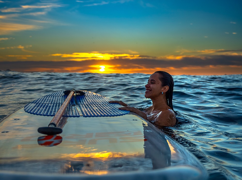 Woman paddleboarding at sunrise on Palmilla Beach, Los Cabos